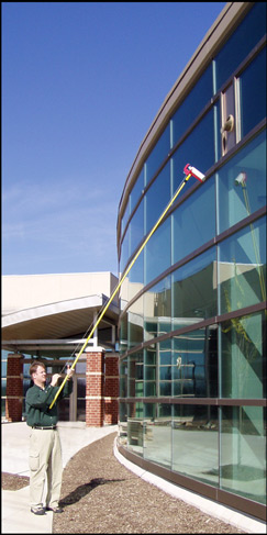 Spraying wasp nest on a commercial building